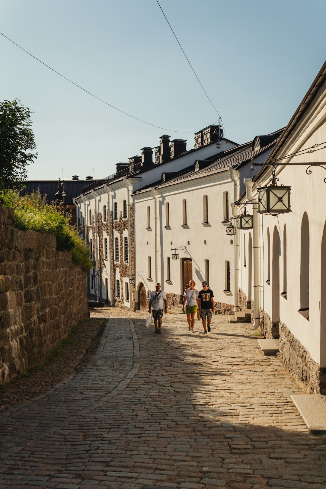 Scandinavian people cycling on a cobblestone street